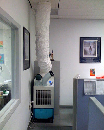 MovinCool Classic Plus 14 portable spot cooler installed in an office